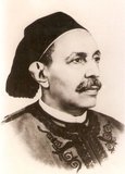 Idris as-Senussi proclaimed an independent Emirate of Cyrenaica in 1949. He was also invited to become Emir of Tripolitania, another of the three traditional regions that now constitute modern Libya (the third being Fezzan). By accepting he began the process of uniting Libya under a single monarchy. A consitution was enacted in 1949 and adopted in October 1951. A National Congress elected Idris as King of Libya, and as Idris I he proclaimed the independence of the United Kingdom of Libya as a sovereign state on 24 December 1951. On 1 September 1969, while Idris was in Turkey for medical treatment, he was deposed in a coup by a group of Libyan army officers under the leadership of Muammar al-Gaddafi. The monarchy was abolished and a republic proclaimed. Idris died at the Sultan Palace in Dokki, Cairo in 1983, aged 94. He was buried at Jannat al-Baqi, Medina, Saudi Arabia.