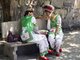 China: Two Bai women in conversation, Bai music and dance festival at San Ta Si (Three Pagodas), Dali, Yunnan