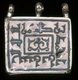 Iran: A ta'wiz or amulet case in silver and nielloware, used for carrying a short verse from the Qur'an for protection and good luck. The Arabic inscription on the face is the shahada or Muslim profession of faith in Kufic script.